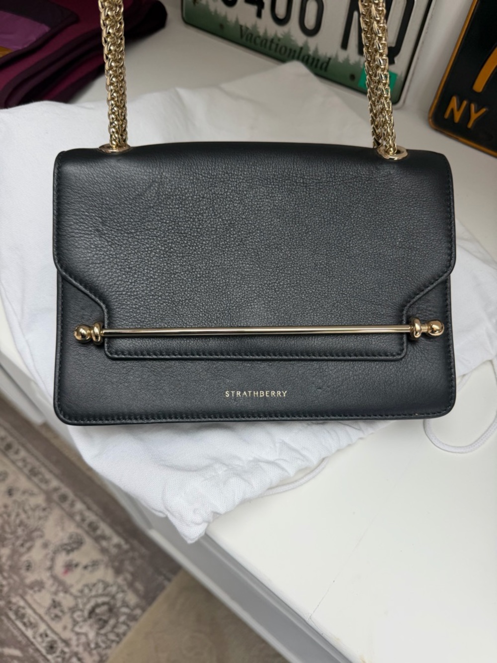 Strathberry Black Leather Shoulder Bag with Gold Bar and Chain